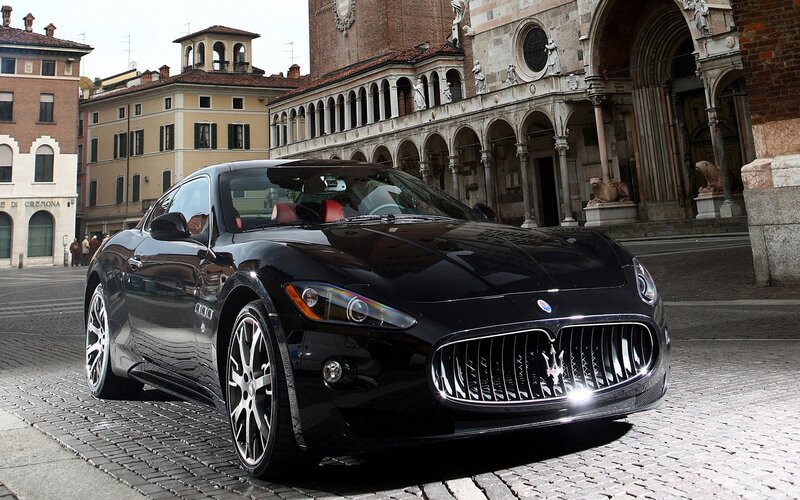 Black Maserati Sports Car — Dramatic, Afternoon, Photograph, Cobblestone Street, Historic Buildings