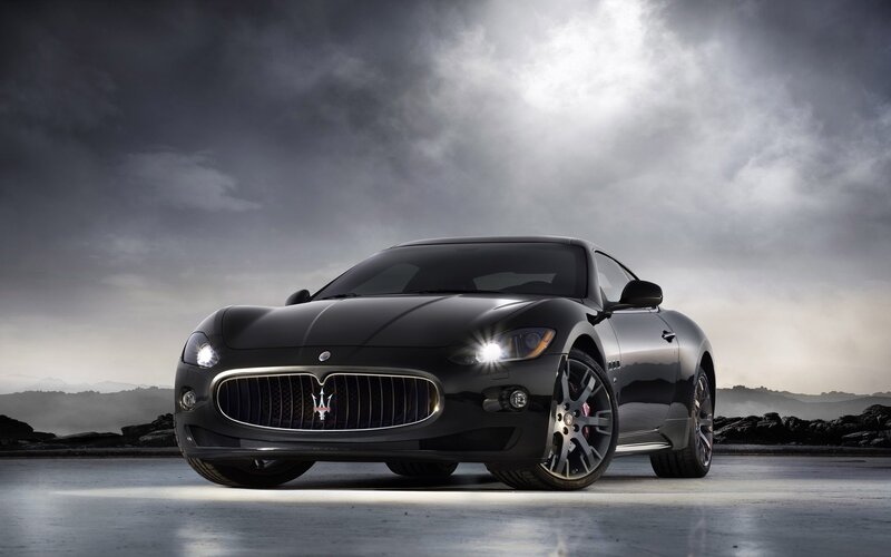 Black Maserati Sports Car — Dramatic, Photograph, Cloudy Sky, Rocks