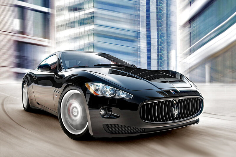 Black Maserati sports car in motion