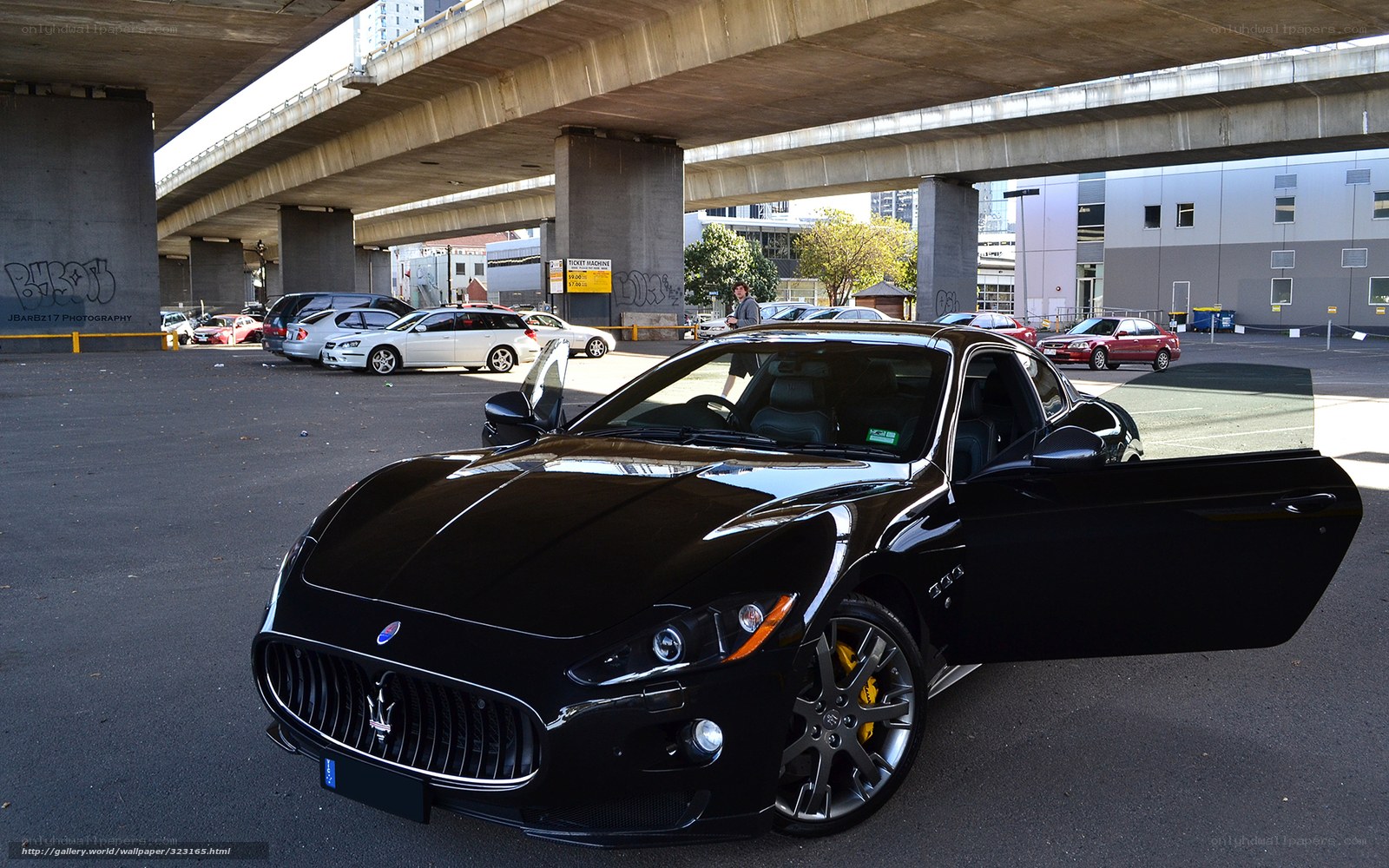 Black Maserati under a bridge
