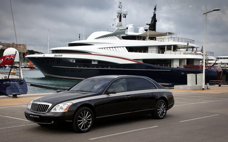 Black Maybach and yacht at marina