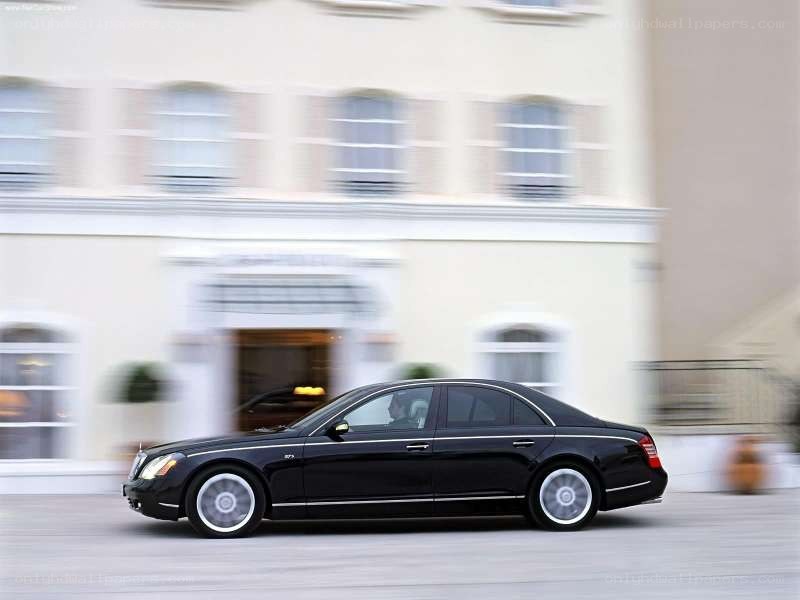 Black Maybach driving past building