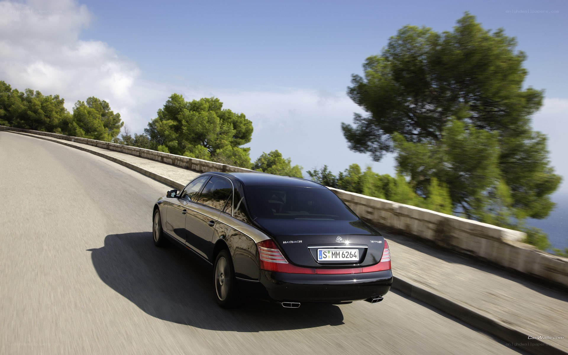 black maybach on coastal road