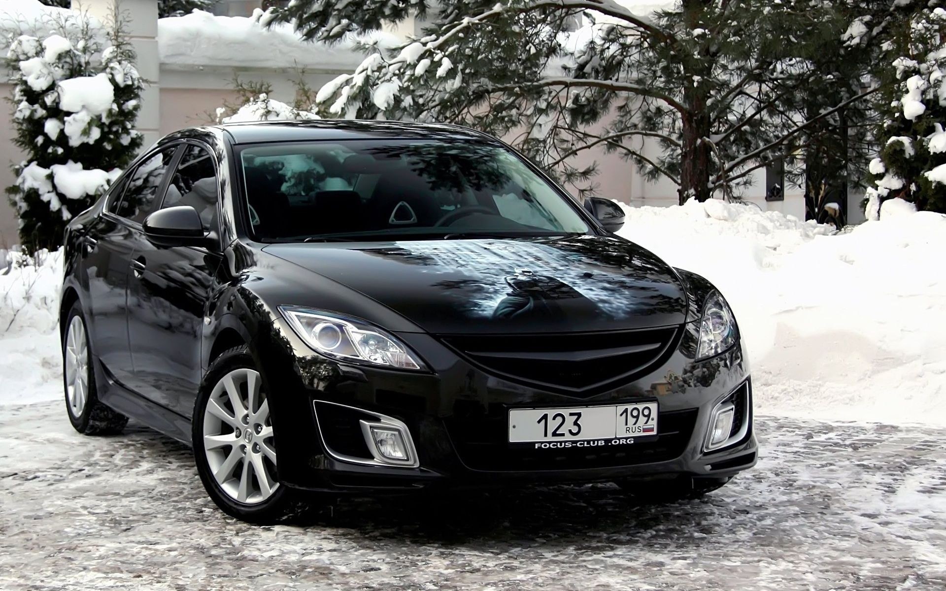Black Mazda 6 in snowy setting