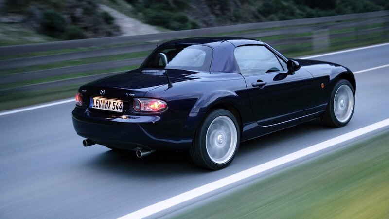 black mazda mx-5 driving on road