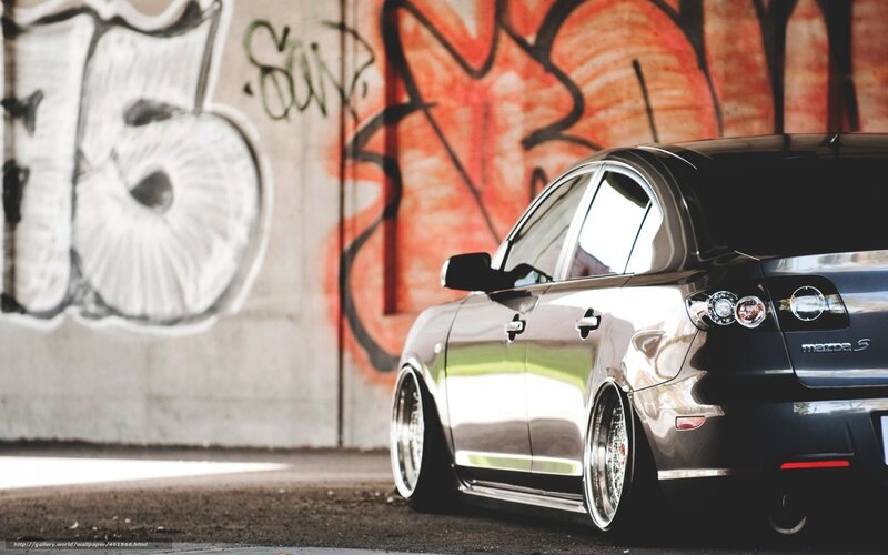 Black Mazda with graffiti background