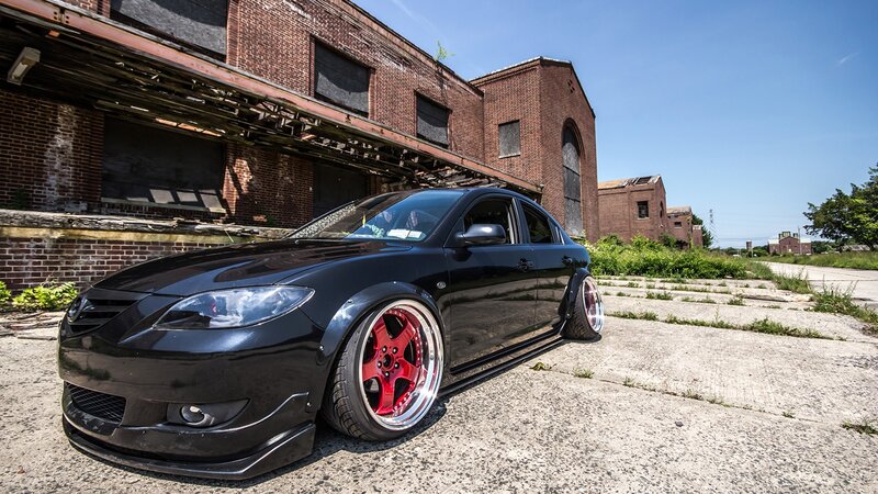 black mazda with red wheels