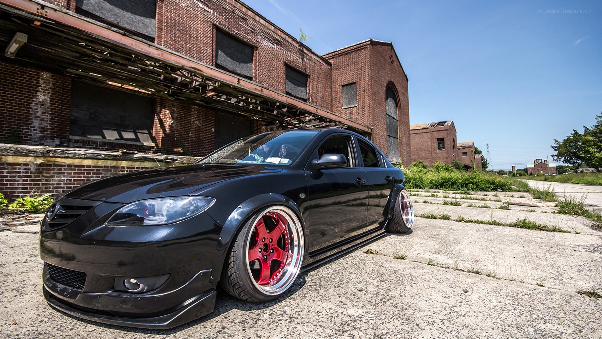 black mazda with red wheels