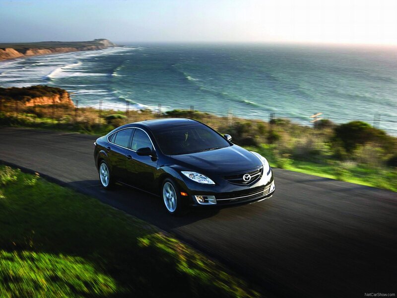 Black Mazda6 on coastal road
