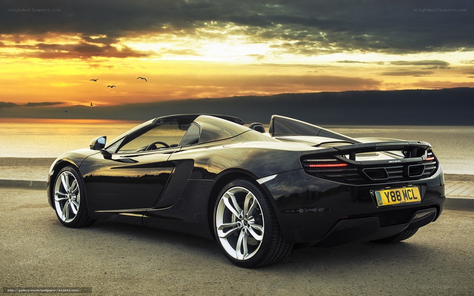 Black McLaren convertible at sunset