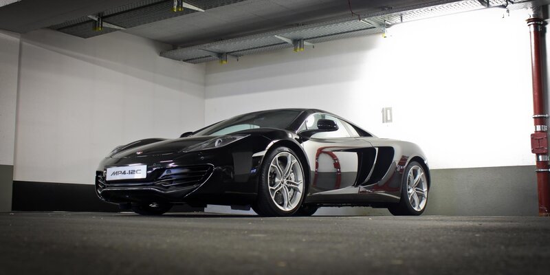 Black McLaren MP4-12C in garage