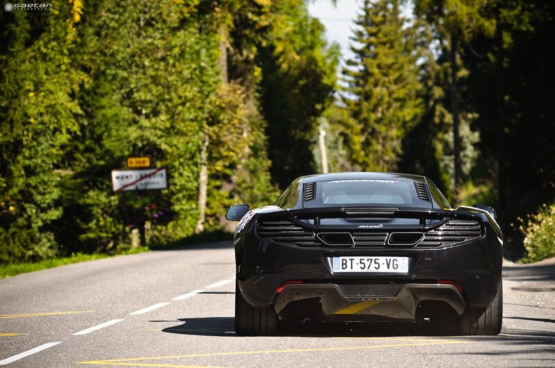 Black McLaren on a forest road