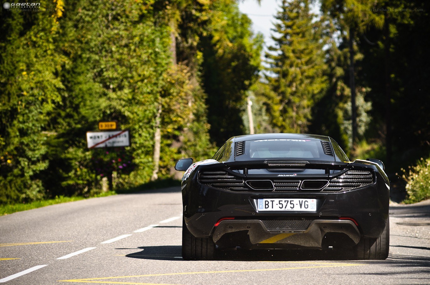 Black McLaren on a forest road