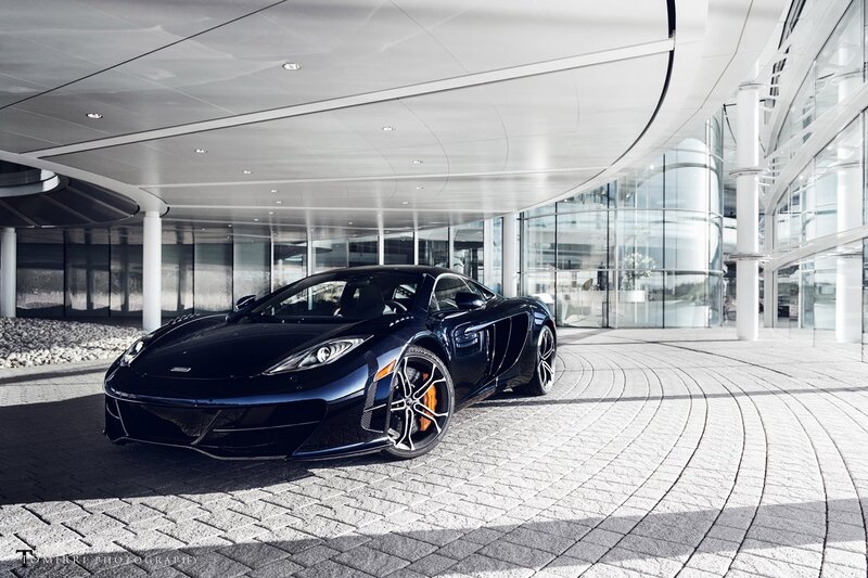 Black McLaren sports car in modern building