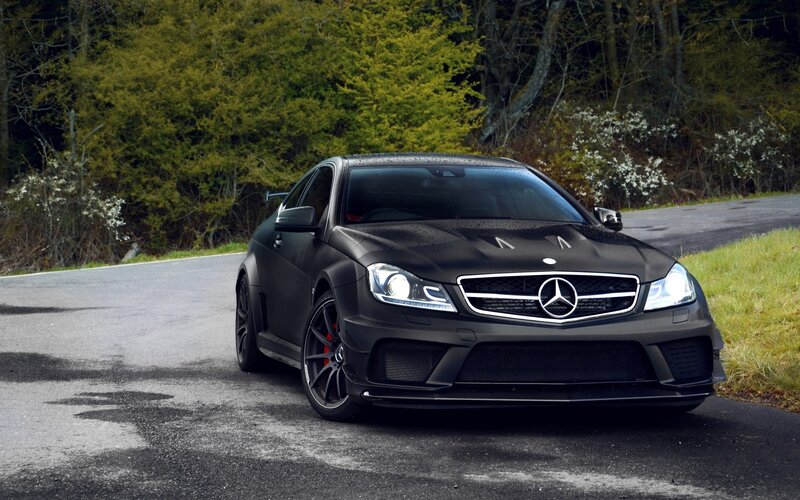 black mercedes-amg on a road