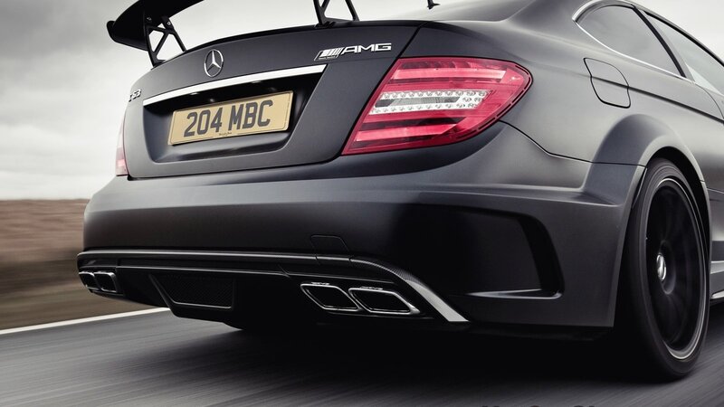 black mercedes-amg on road