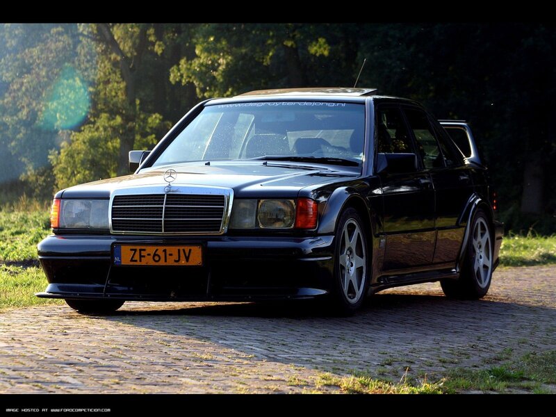 Black Mercedes-Benz 190E on cobblestones