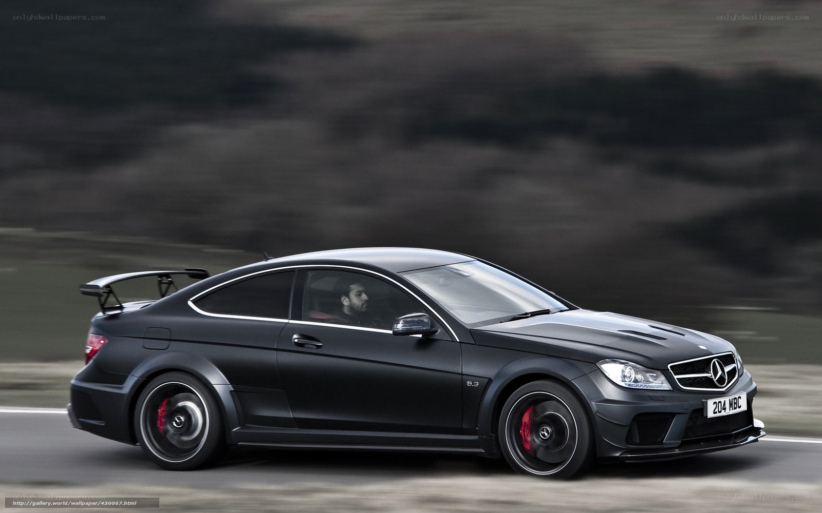 black mercedes-benz c63 amg in motion