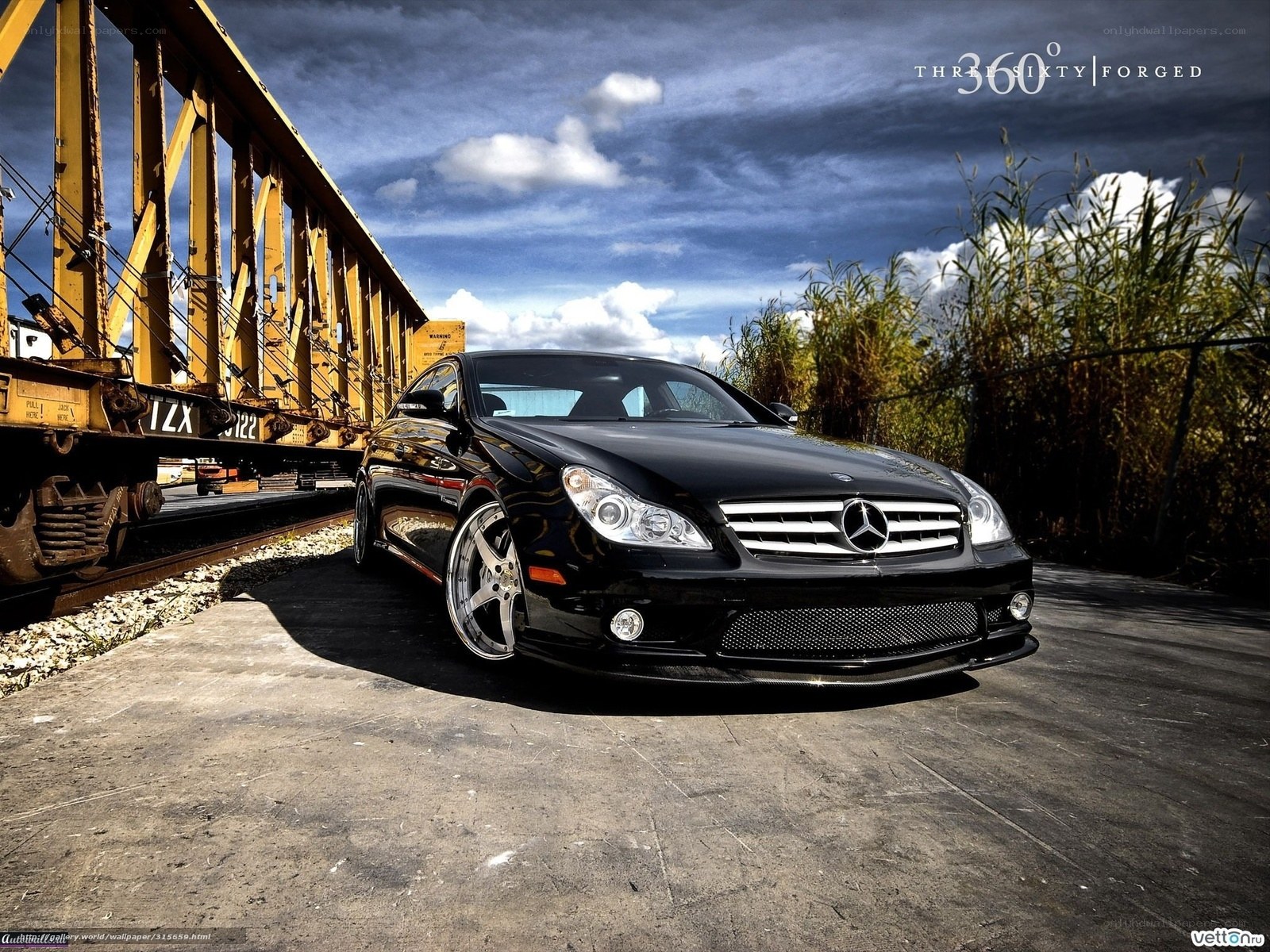Black Mercedes-Benz CLS on train tracks