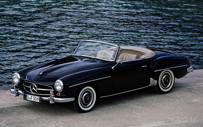 Black Mercedes-Benz convertible by water