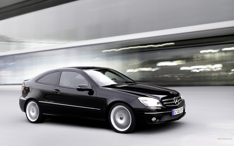 black mercedes-benz coupe in motion