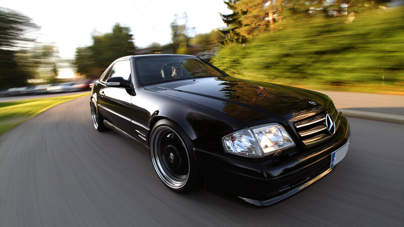black mercedes-benz coupe in motion