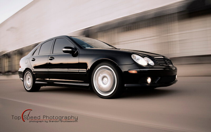 Black Mercedes-Benz in motion