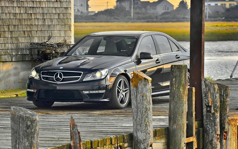 Black Mercedes-Benz on a wooden dock