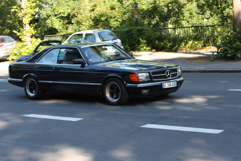 black mercedes coupe on street