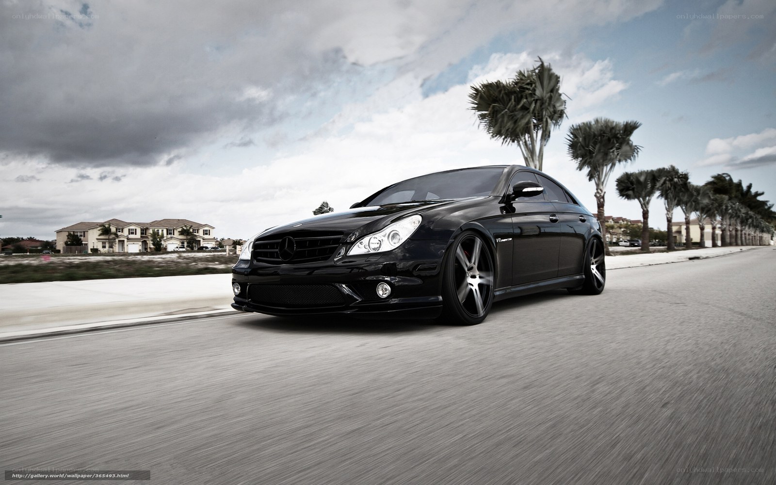 black mercedes driving on street