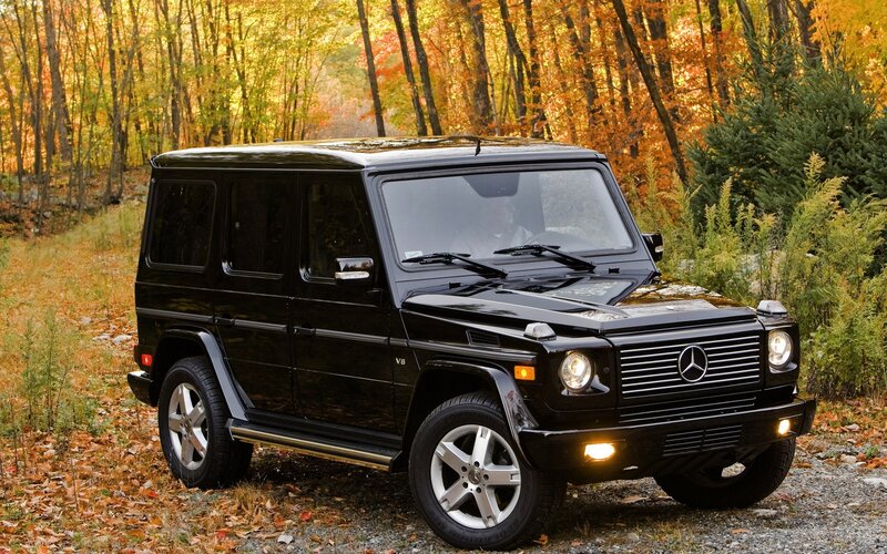 Black Mercedes G-Wagon in autumn forest
