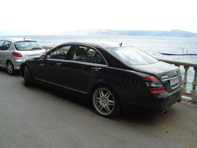 Black Mercedes parked by the sea