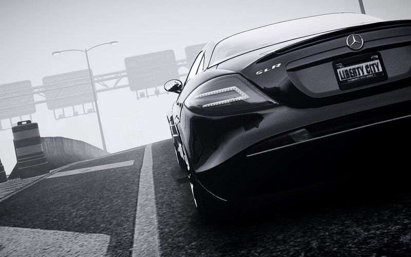 Black Mercedes SLR on a foggy highway