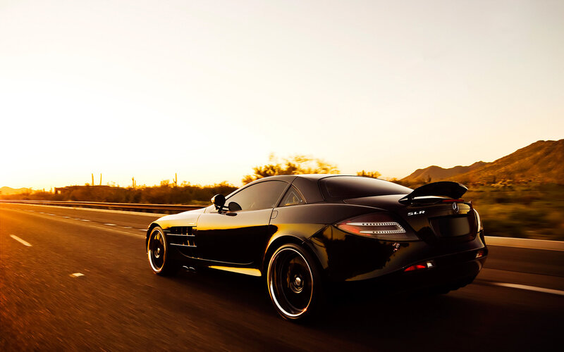 Black Mercedes SLR on desert highway