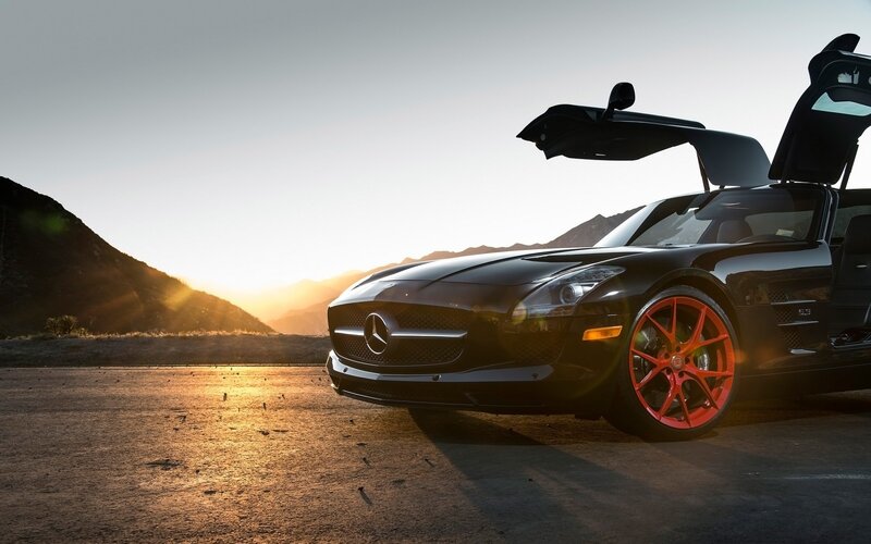Black Mercedes SLS with red wheels