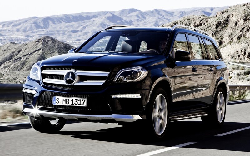 black mercedes suv on mountain road