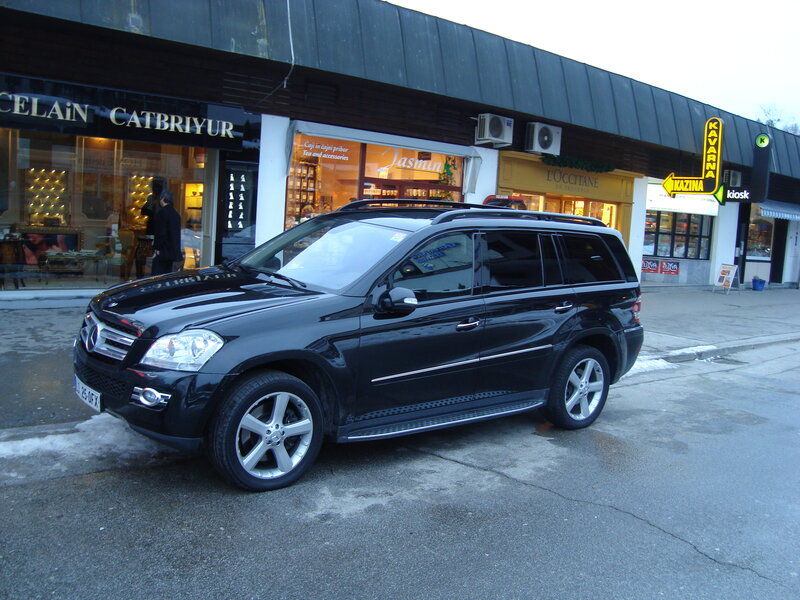 Black Mercedes SUV parked on street