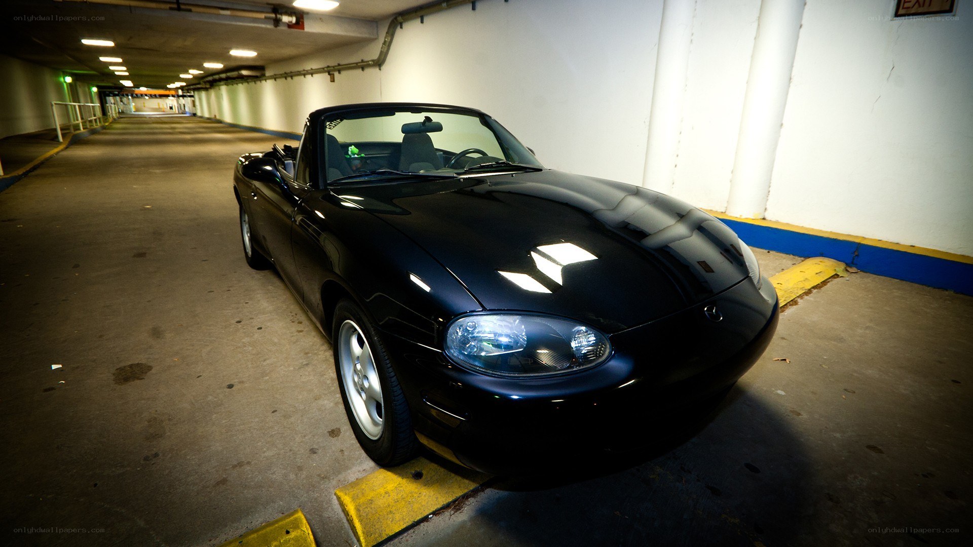 Black Miata in parking garage