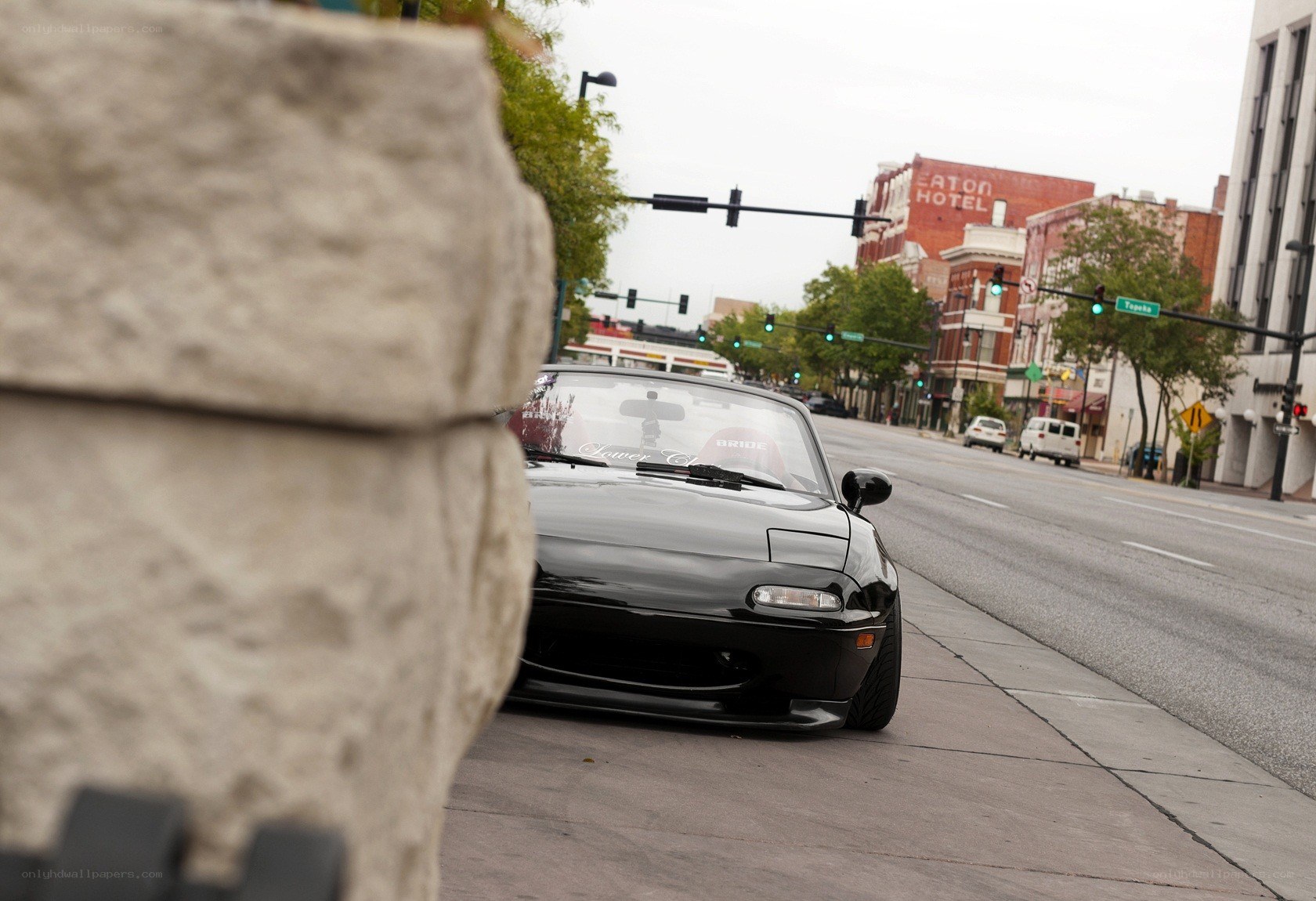 Black Miata on city street
