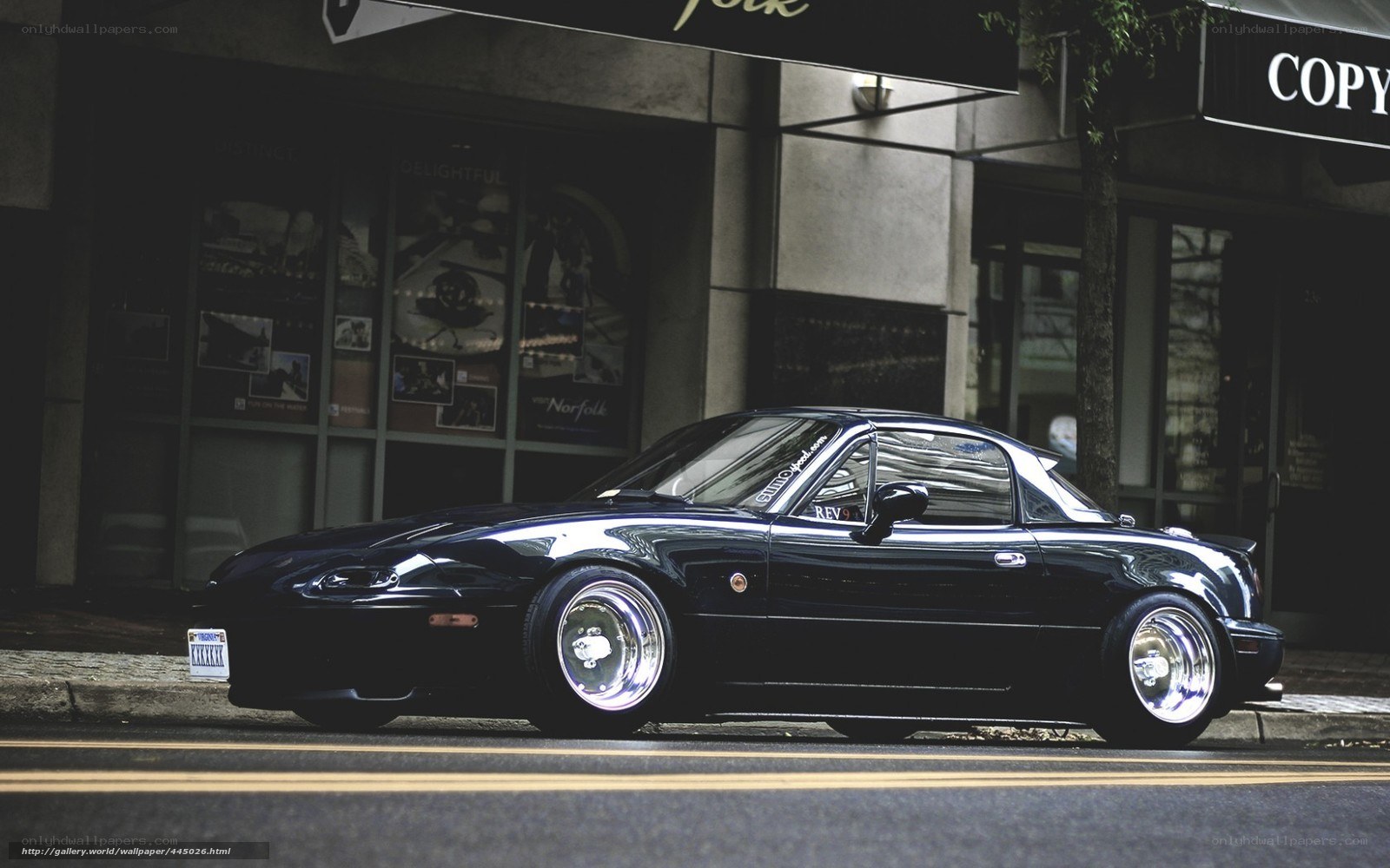 Black Miata on city street