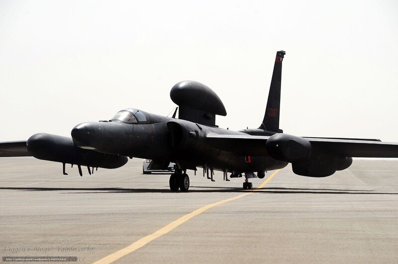 Black military aircraft on tarmac