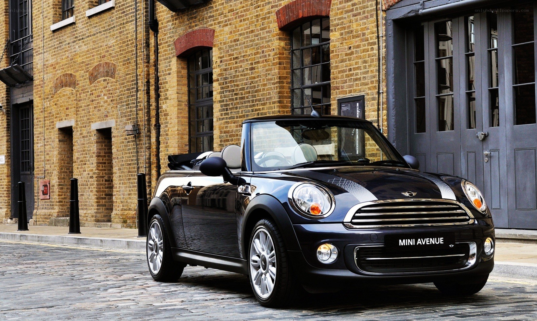 Black MINI convertible on cobblestone street