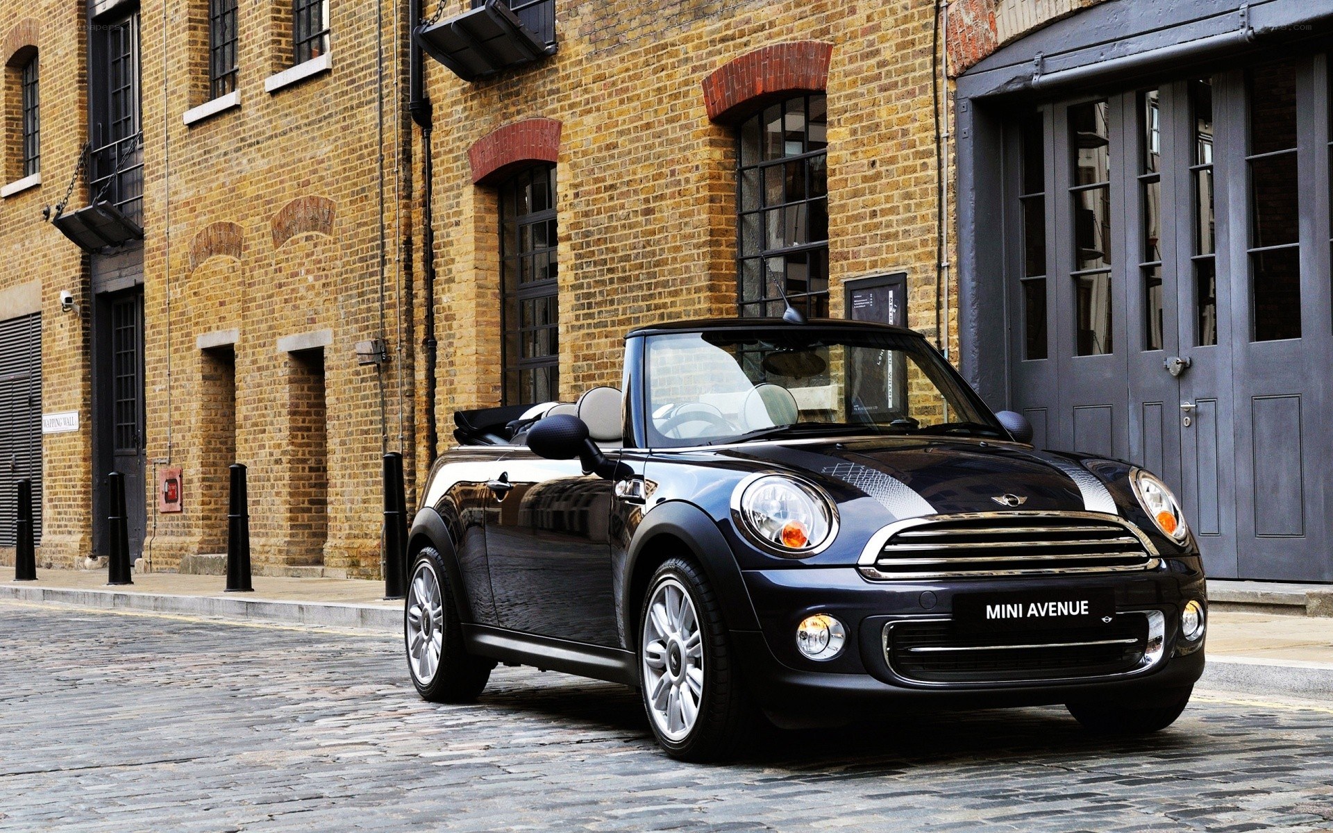 Black MINI convertible on cobblestone street