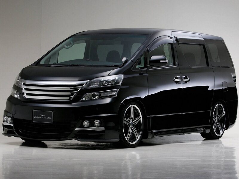 Black minivan with custom wheels
