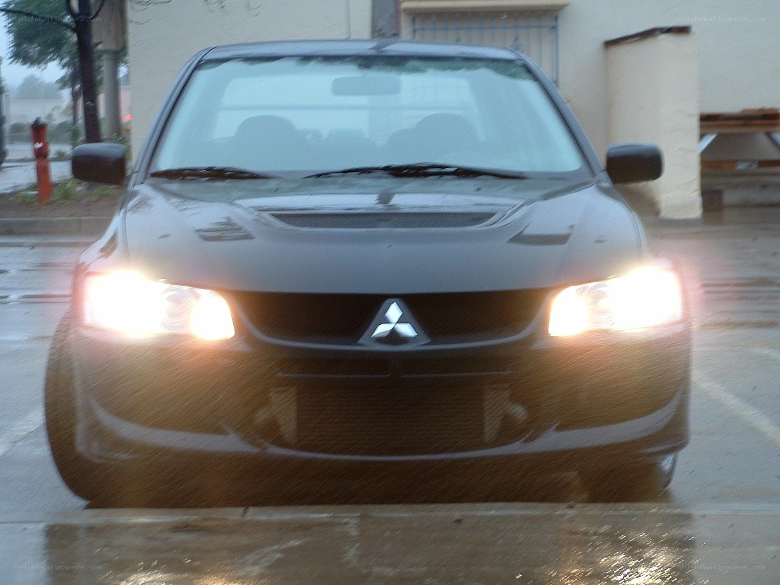 black mitsubishi lancer in rain