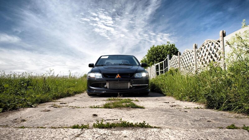 Black Mitsubishi Lancer on a rural path