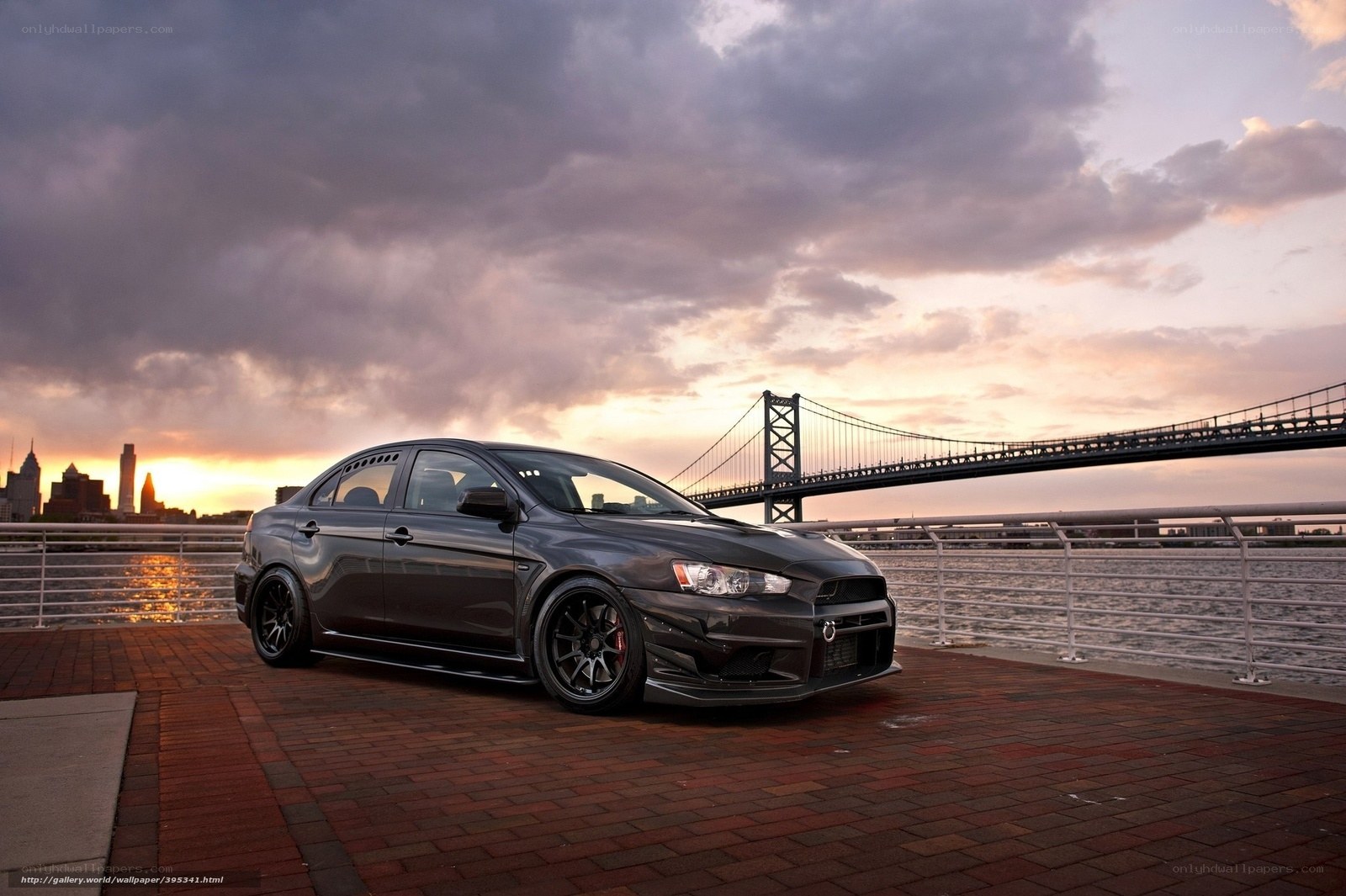 Black Mitsubishi on a pier at sunset