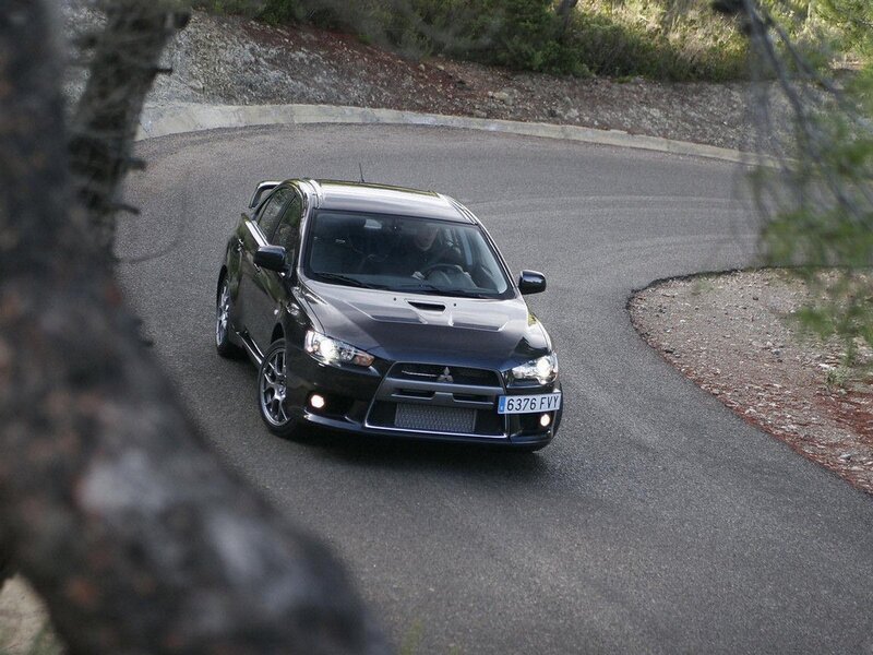 black mitsubishi on winding road
