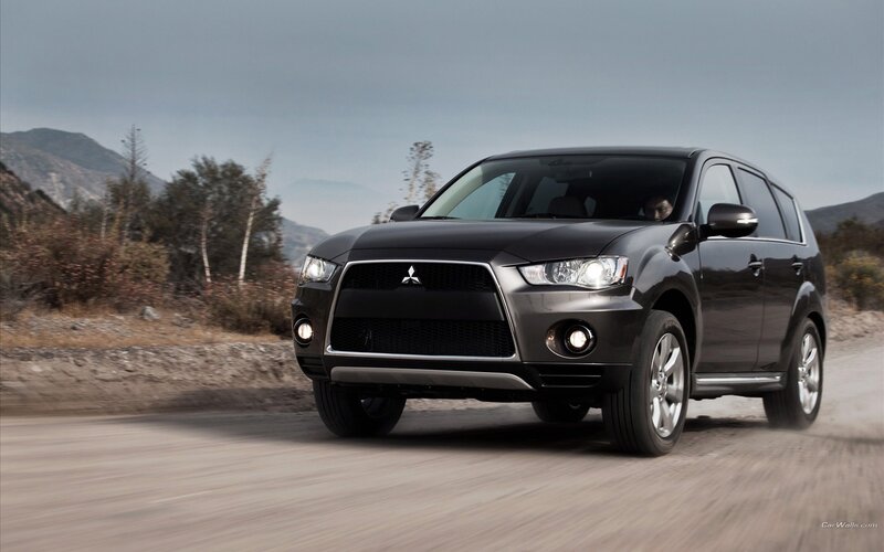 Black Mitsubishi SUV on a dirt road