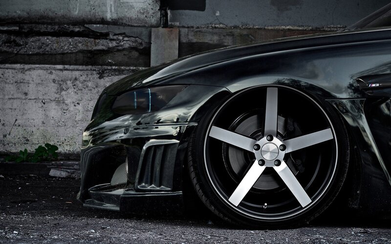 Black Modified Car — Dramatic, Photograph, Car Wheel, Concrete Wall